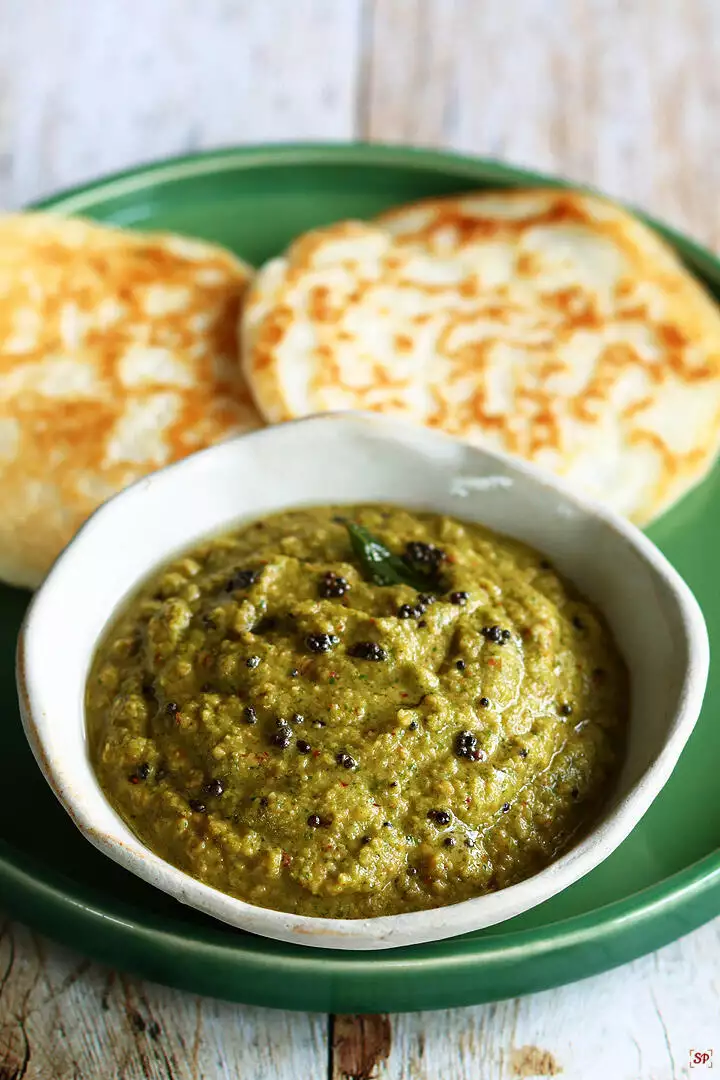 coriander chutney placed in a small beige color bowl