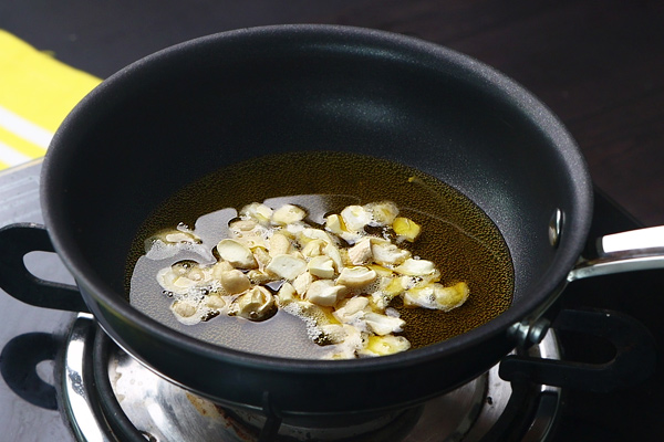 heat ghee add cashews