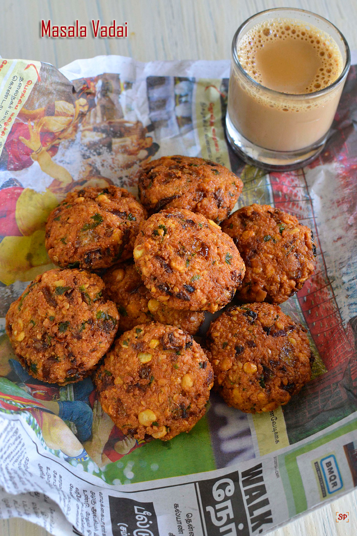 masala vada packed in newspaper and tea on the side