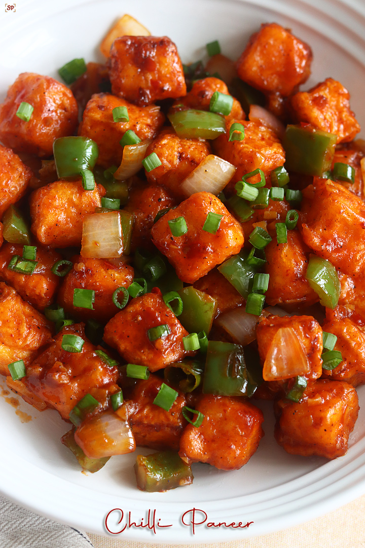 chilli paneer placed in a rimmed white bowl