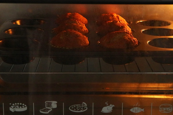 muffins baking in preheated oven