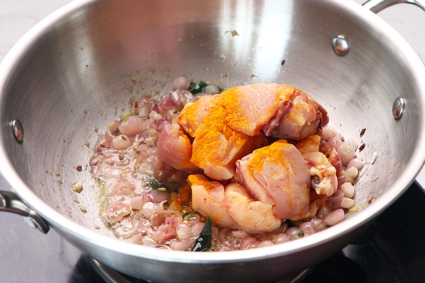 add chicken with turmeric powder