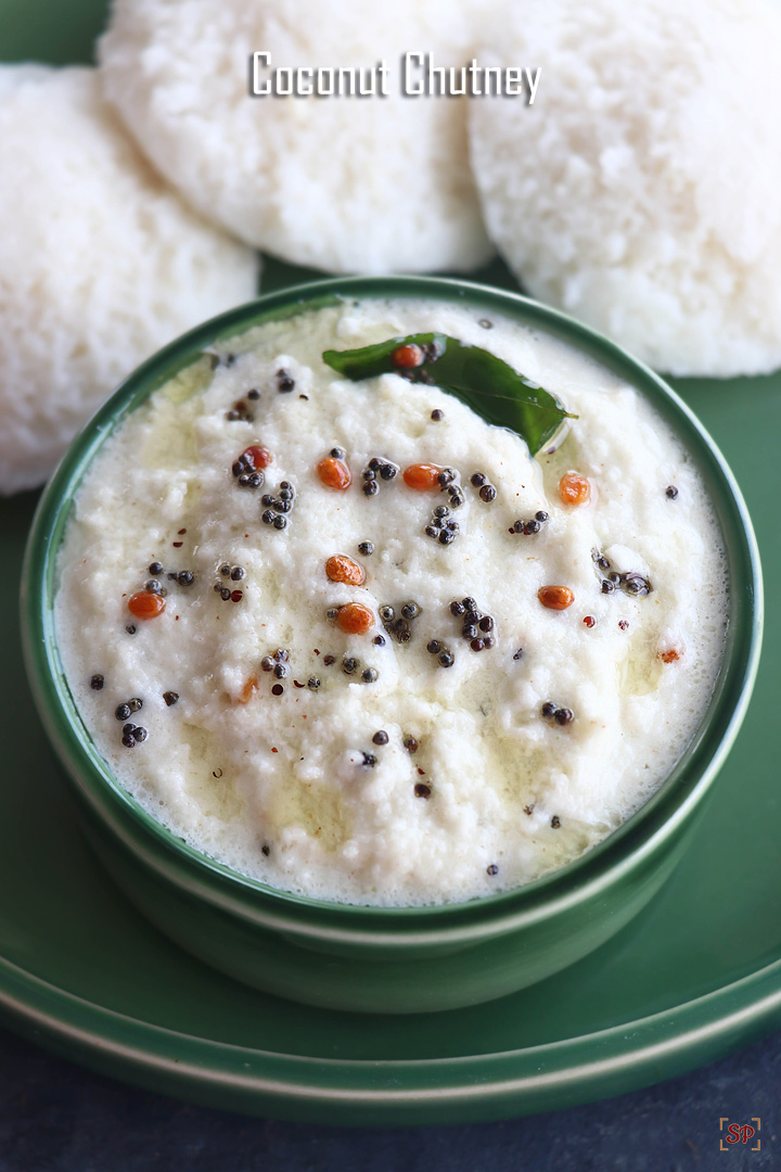 coconut chutney in a green bowl with idlis