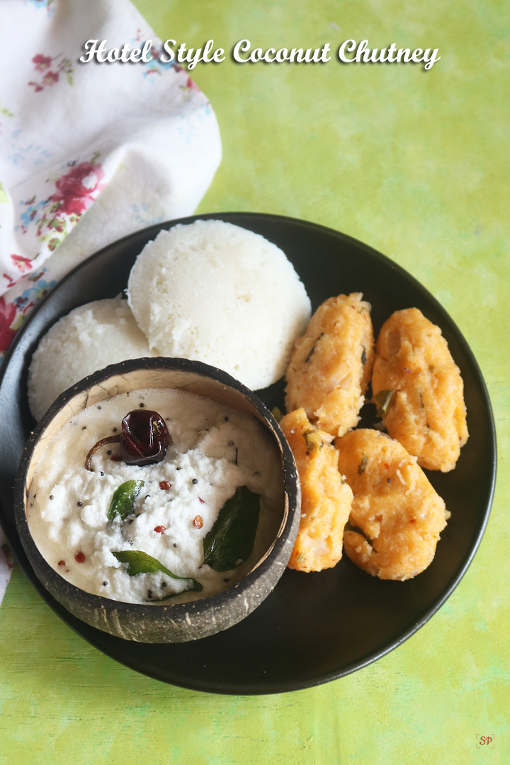 hotel style coconut chutney in a coconut shell bowl with idli and dumplings