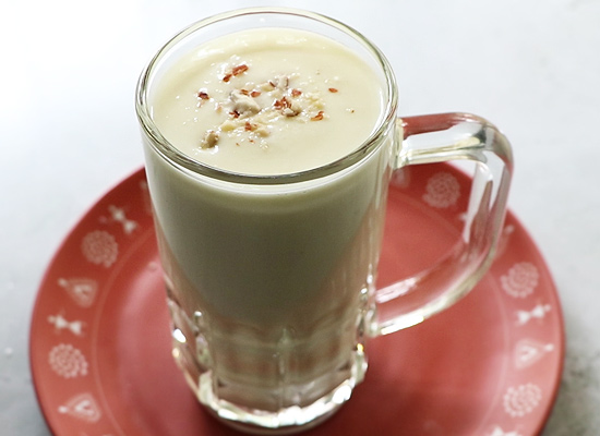 sweet lassi garnished with crushed almonds