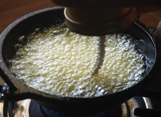 butter murukku recipe press over hot oil