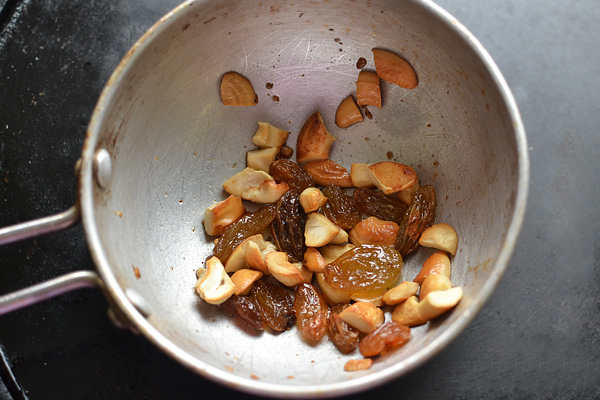 aval laddu recipe - fry cashews and raisins in ghee