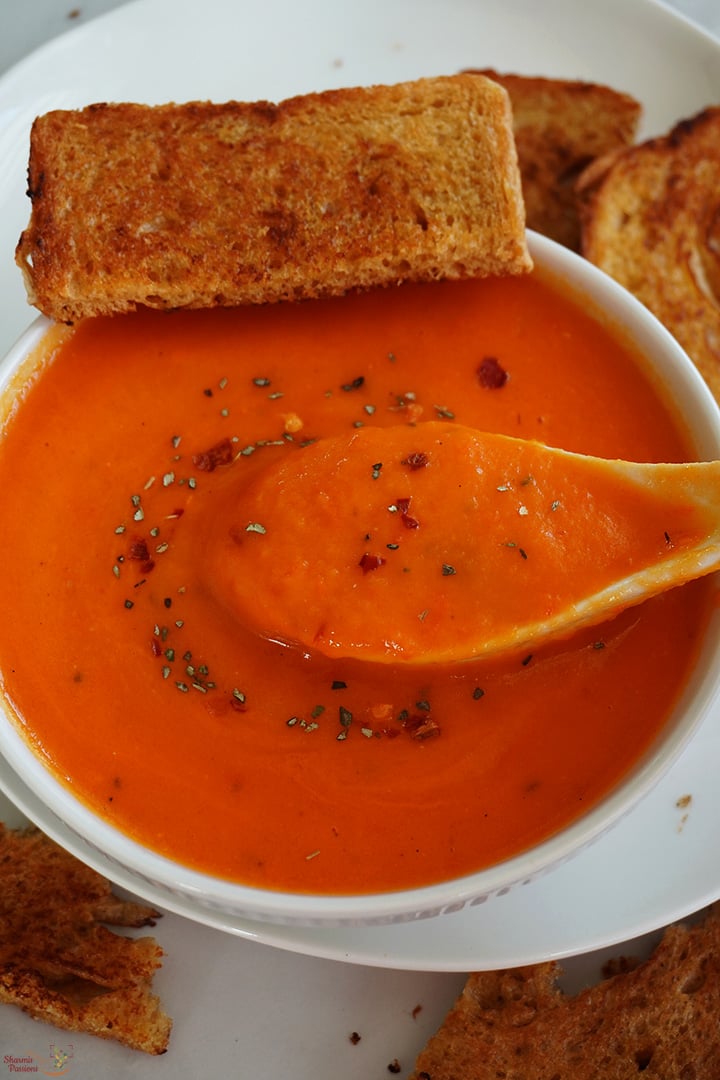 red bell pepper soup served with toasted bread