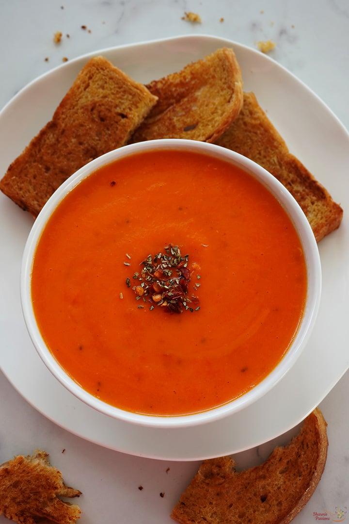 red bell pepper soup served with toasted bread
