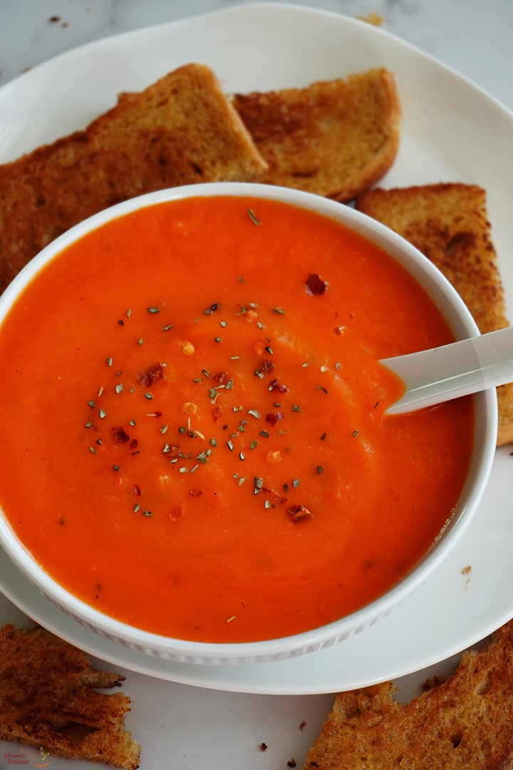 red bell pepper soup served with toasted bread
