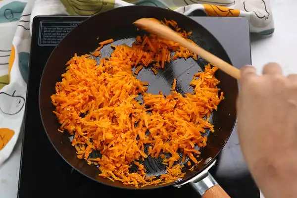 add grated carrot and saute until raw smell leaves