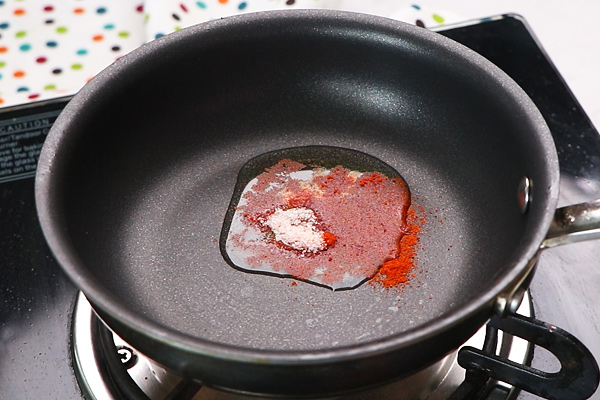 add spice powders to oil