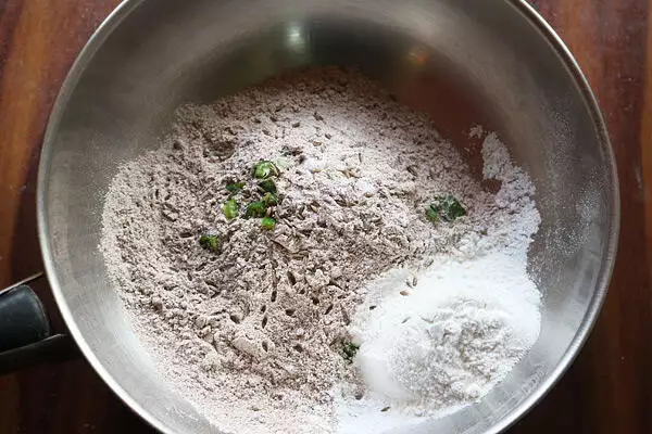 add flour, cumin seeds and green chili