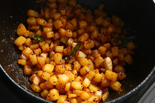 potatoes are mixed well with the spices