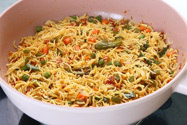 the rice is mixed well with vegetables and masalas