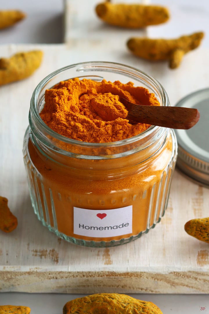 homemade turmeric powder stored in a glass jar