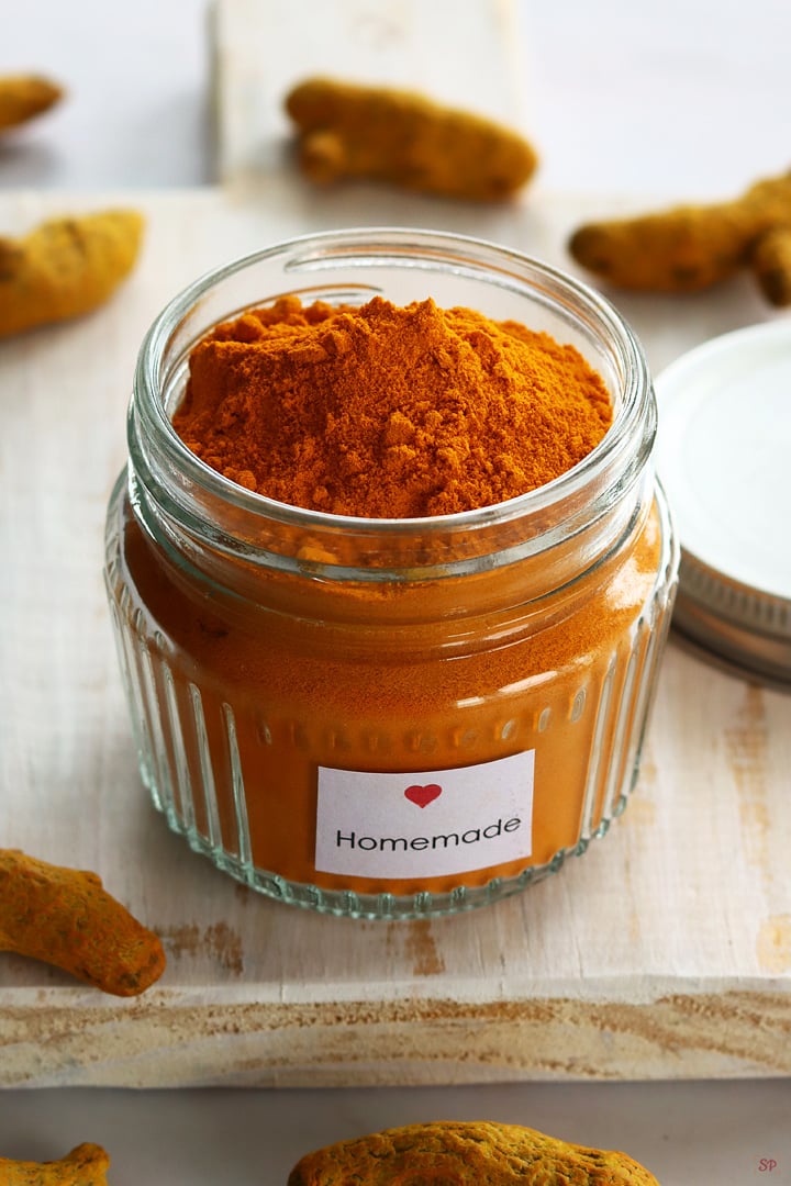 homemade turmeric powder stored in a glass jar