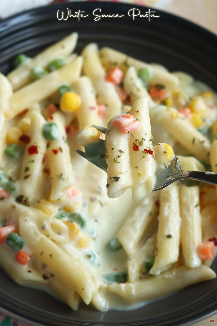 white sauce pasta served in a grey pasta bowl