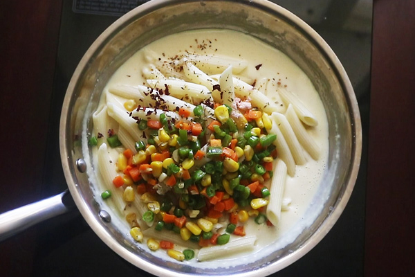 add vegetables and cooked pasta along with seasoning