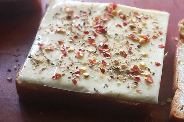 place a cheese slice or sprinkle grated cheese. sprinkle with spices.