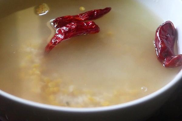 rinse and soak rice, dal along with red chillies in water