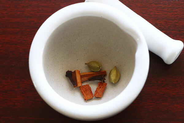 the spices are added to mortar pestle