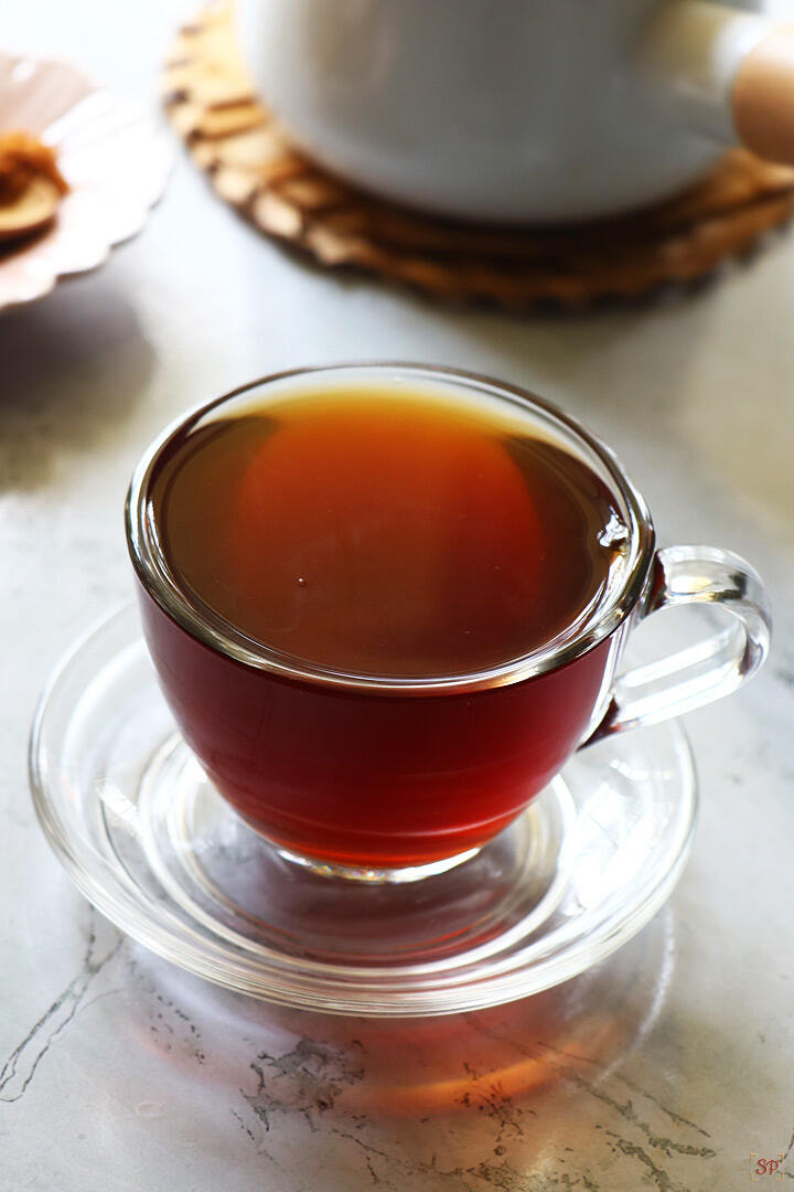 black tea served in a glass cup and saucer