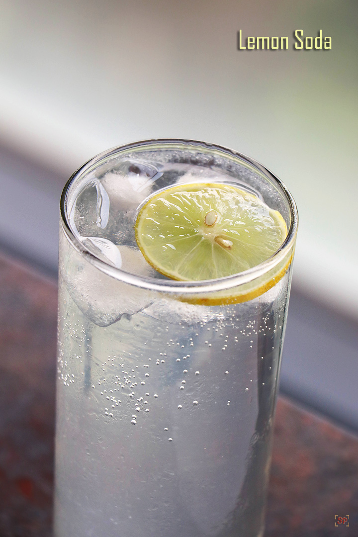 lemon soda served in a tall glass with ice cubes