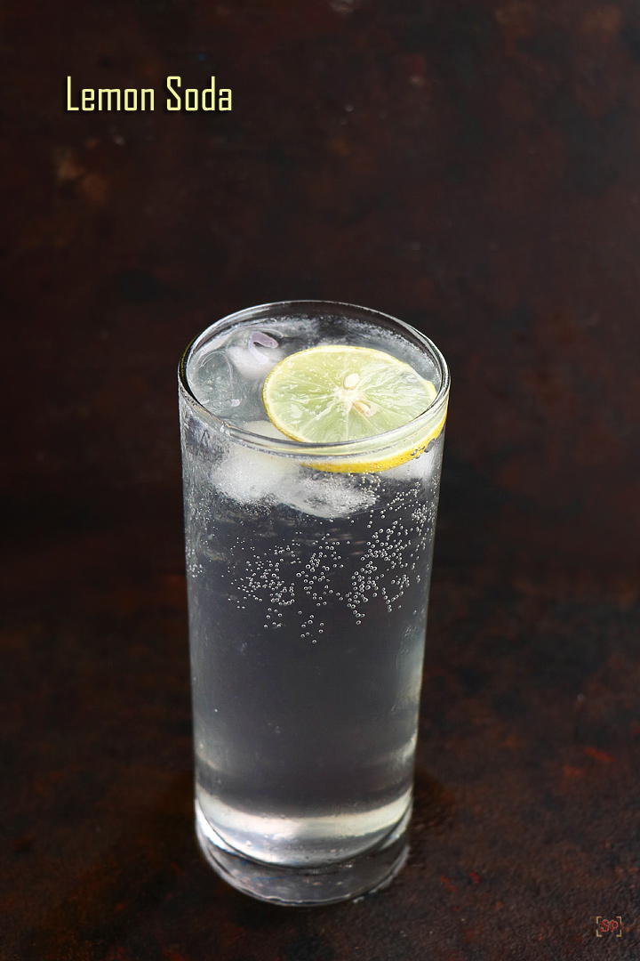 lemon soda served in a tall glass with ice cubes