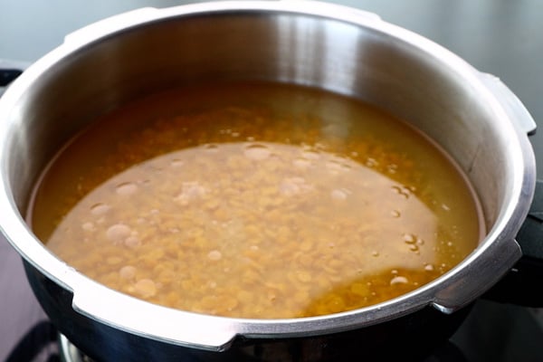 add rice, dal, turmeric, oil, water