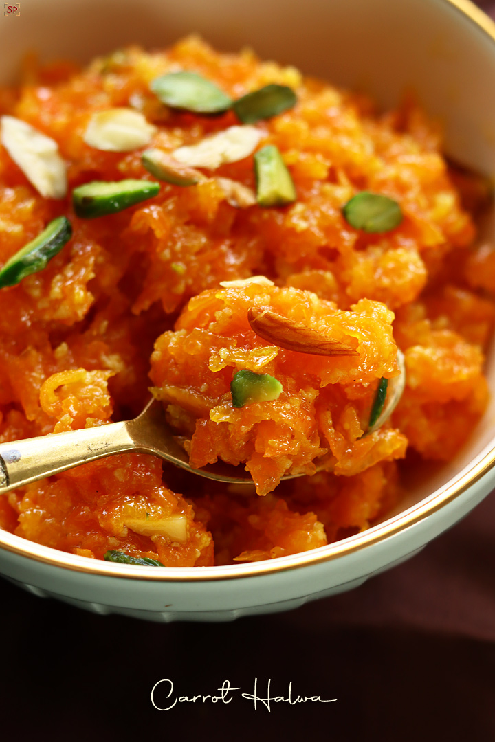 carrot halwa in a gold spoon in a bowl