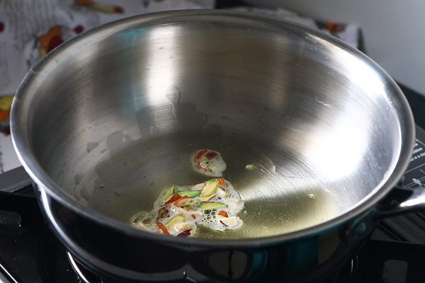 heat ghee and add the nuts to fry