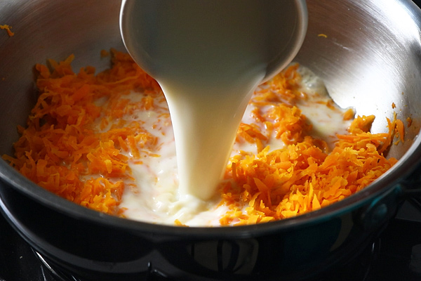 milk is being added to carrot halwa
