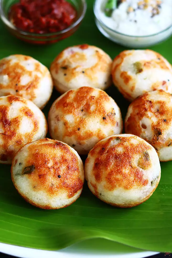 paniyaram served in banana leaf along with coconut chutney and garlic chutney