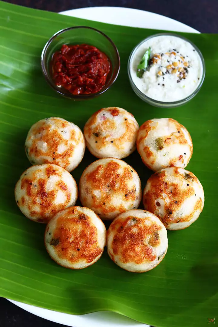 paniyaram served in banana leaf along with coconut chutney and garlic chutney