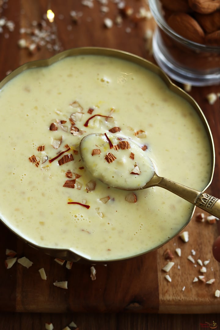 badam kheer served in a gold color bowl