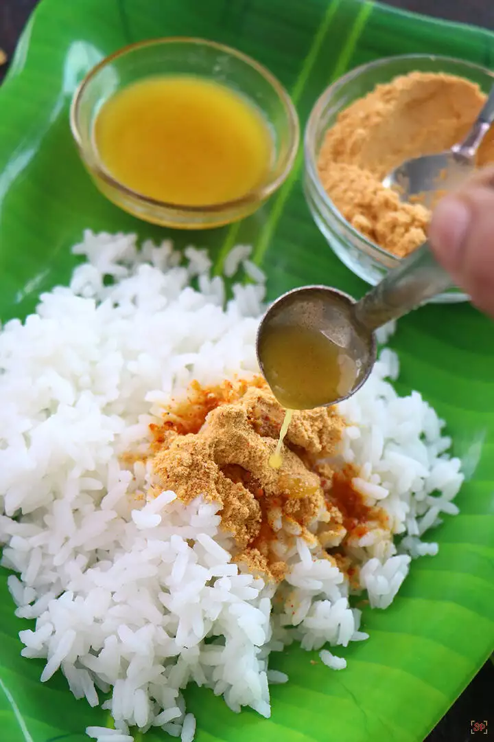 paruppu podi with rice and ghee in a banana leaf plate