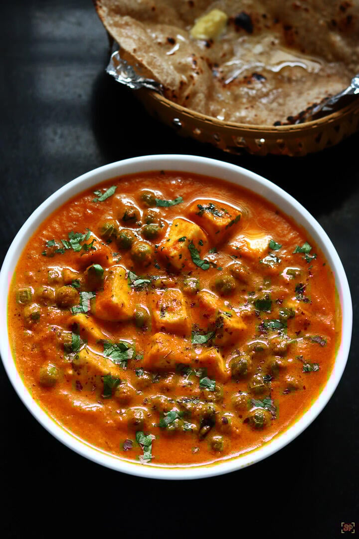 matar paneer served in a white bowl