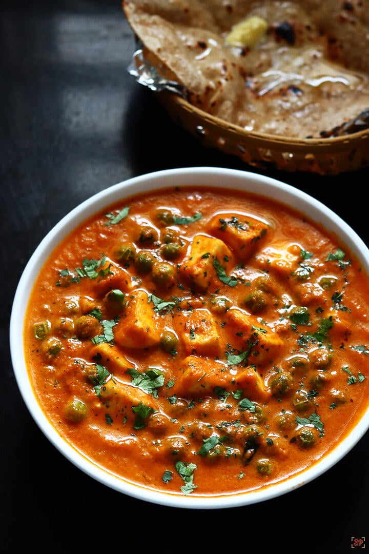 matar paneer served in a white bowl