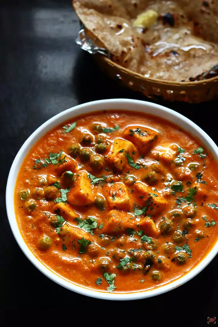 matar paneer served in a white bowl