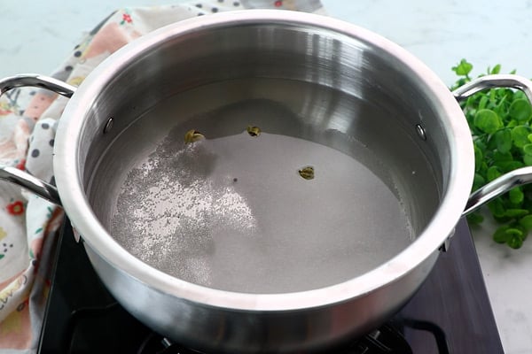 add sugar, cardamom and water