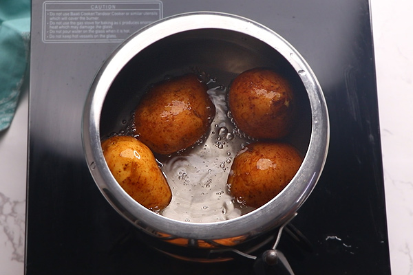 potatoes are added along with water to pressure cooker