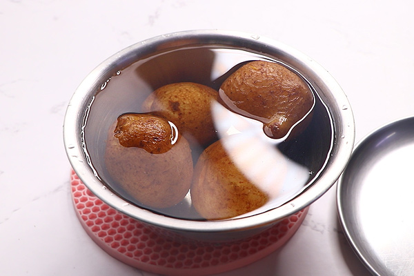 potatoes are added to a bowl with cold water