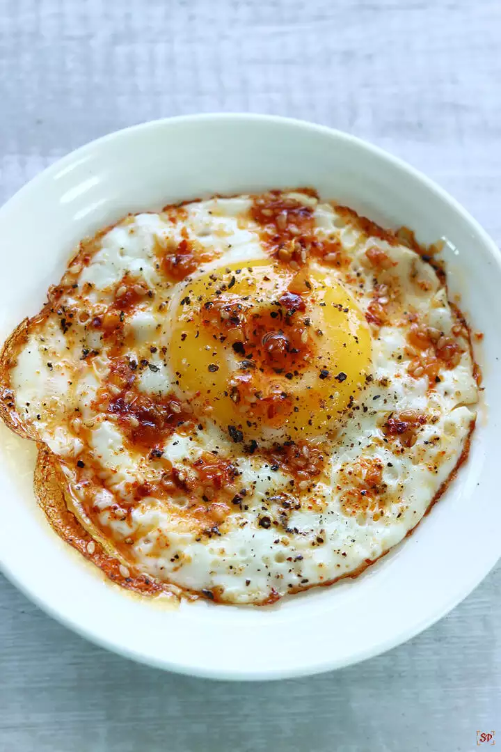 bulls eye eggs with chili oil drizzle over it
