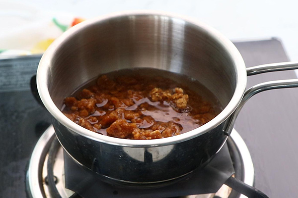 Crush the jaggery and add water.