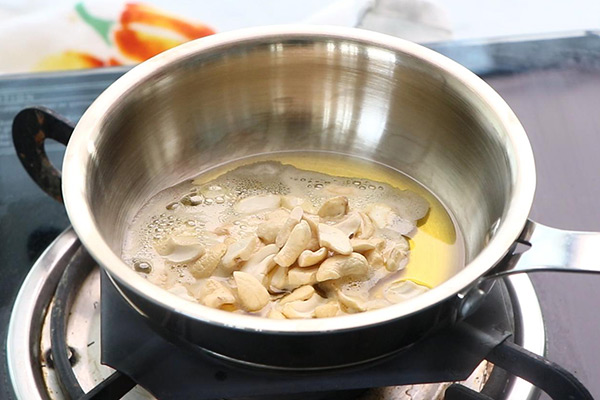 Heat ghee, add cashew nuts
