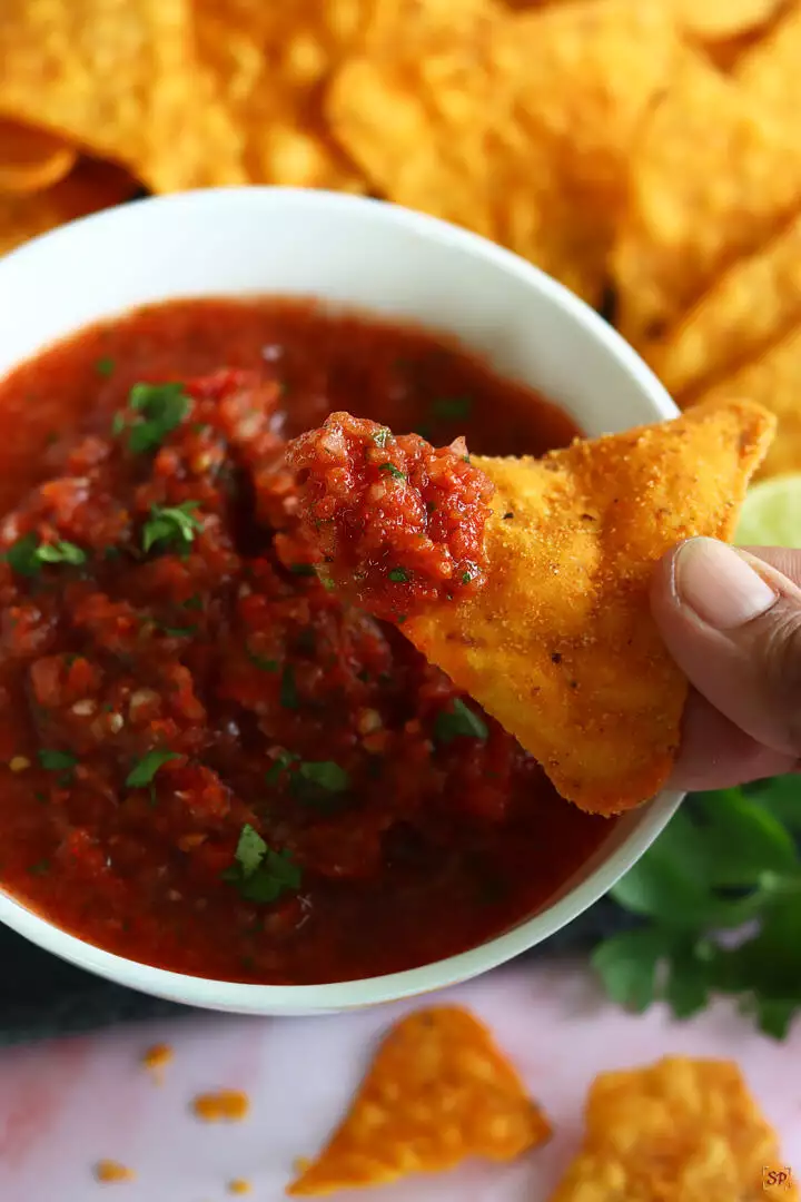 salsa dipped with tortilla chips