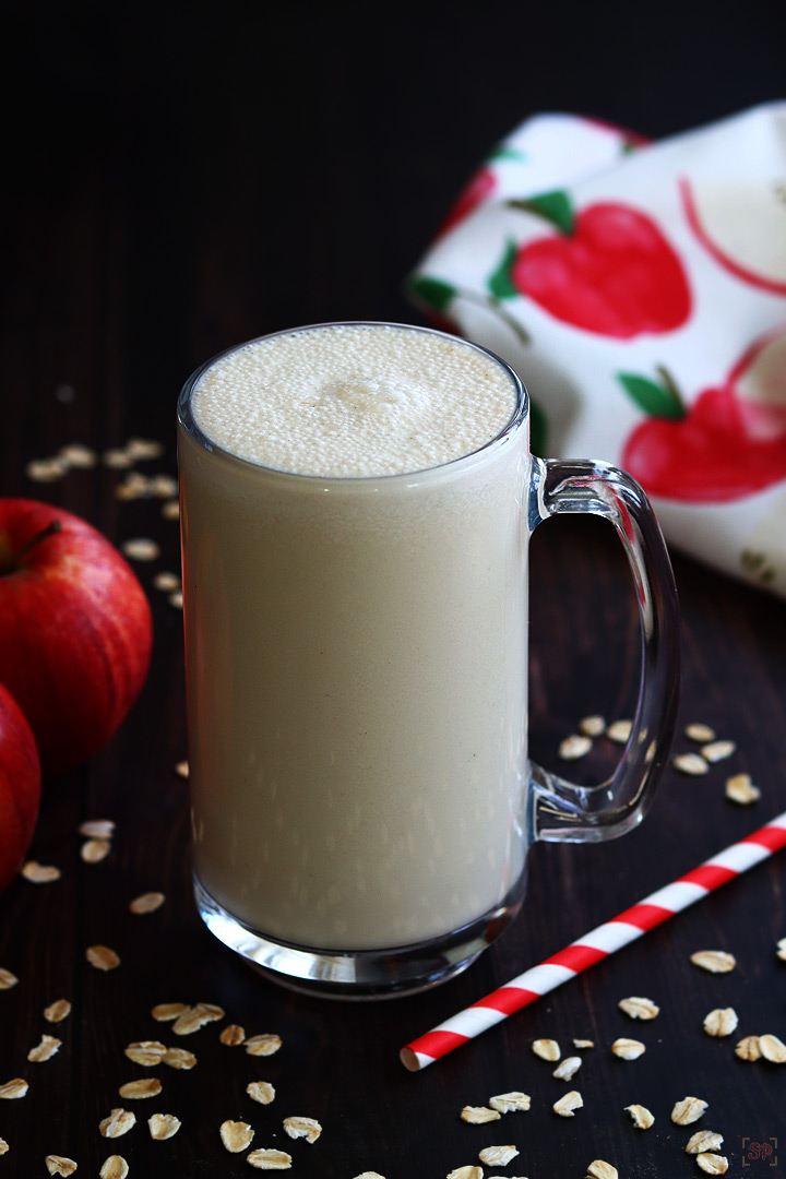 apple smoothie served in a tall glass mug
