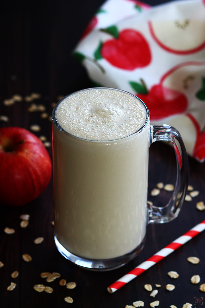 apple smoothie served in a tall glass mug