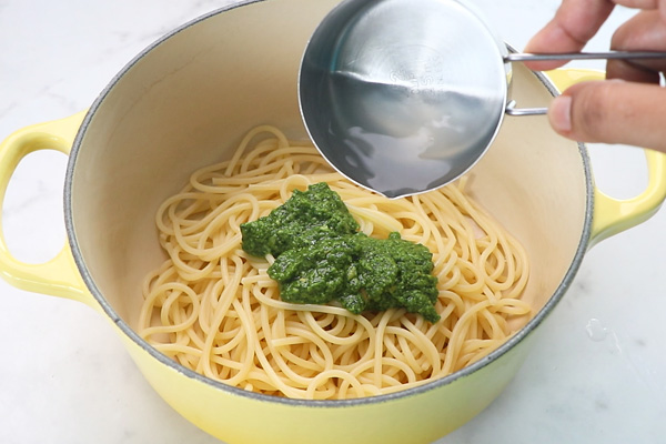 add pesto sauce and pasta cooked water